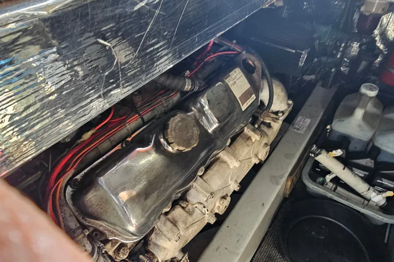 Slide: The Image of Engine compartment of a 1990 Mediterranean 38 Convertible boat, showcasing mechanical components. - 40