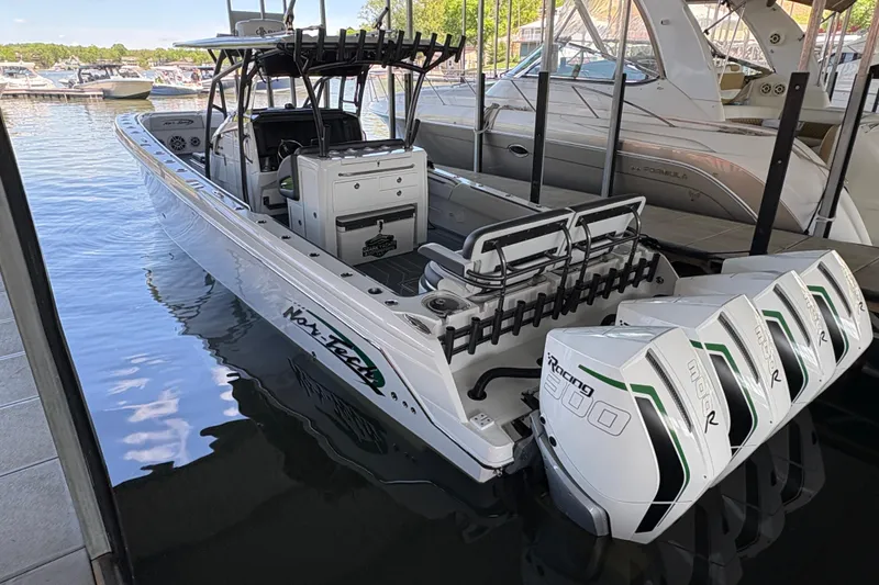 Slide: The Image of 2022 Nor-Tech 392 Super Fish boat docked with powerful outboard engines. - 1
