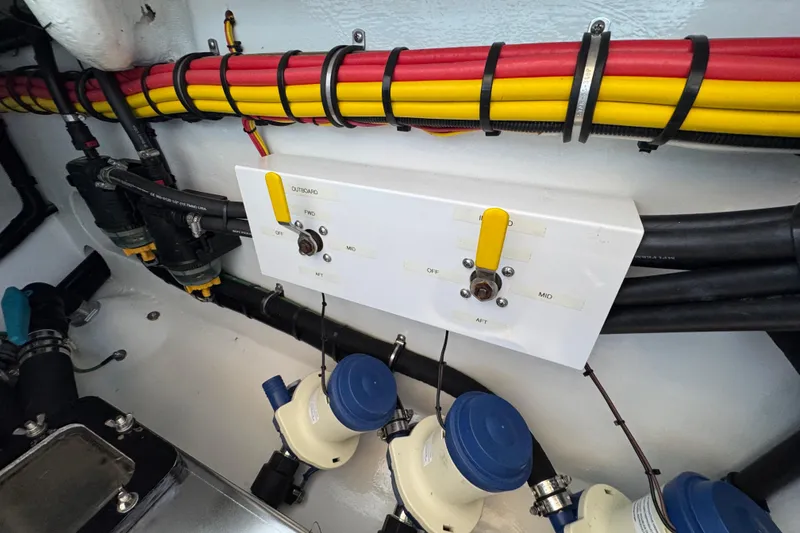 Slide: The Image of Engine compartment of a 2022 Nor-Tech 392 Super Fish, showcasing detailed wiring and components. - 13