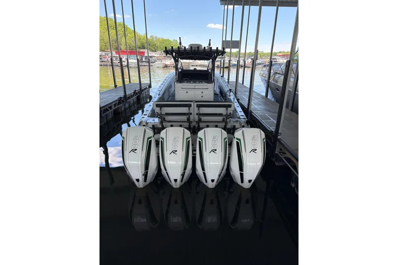 Slide: The Image of 2022 Nor-Tech 392 Super Fish boat docked with multiple engines, ready for fishing. - 2