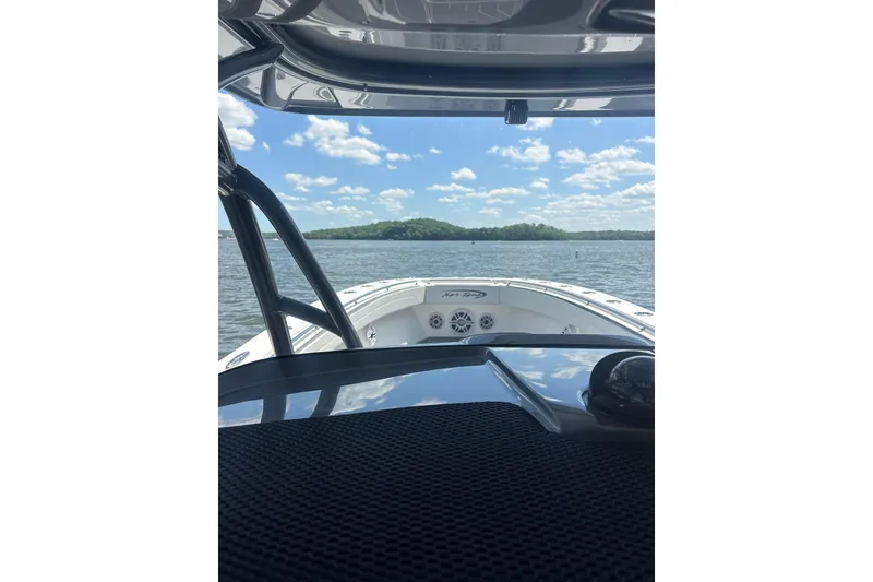Slide: The Image of 2022 Nor-Tech 392 Super Fish boat dashboard with advanced Garmin navigation system on a sunny day. - 7