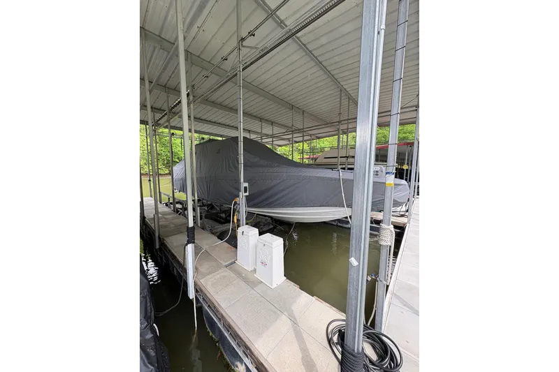 Slide: The Image of 2022 Nor-Tech 392 Super Fish boat covered and docked in a marina. - 16