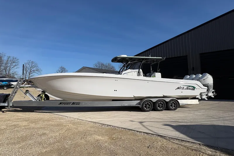 Slide: The Image of 2022 Nor-Tech 392 Super Fish boat on trailer, parked outdoors under clear blue sky. - 3