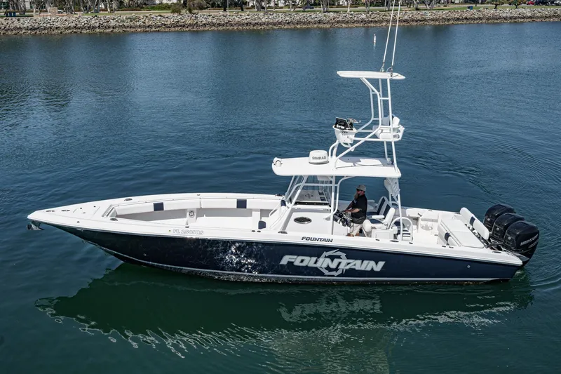 The Image of 2019 Fountain 38 CC boat cruising on calm water, side view. - 1
