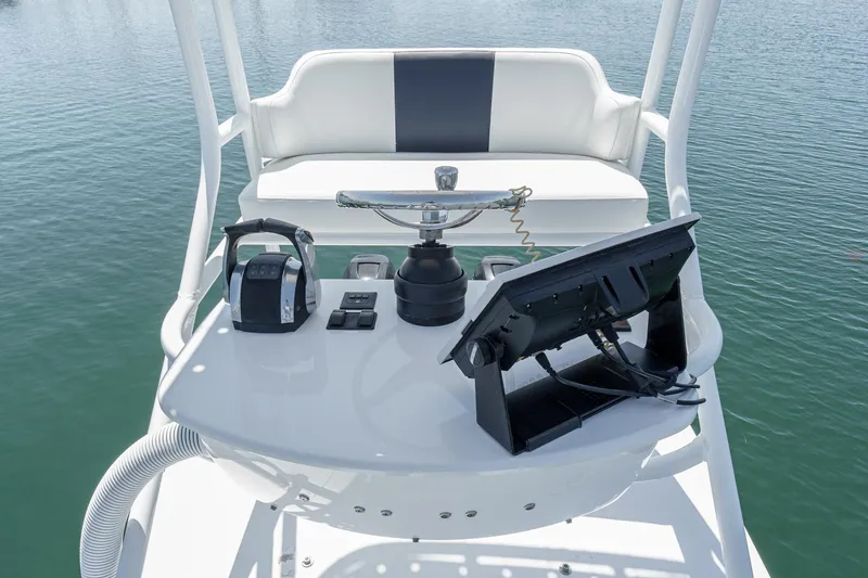 Slide: The Image of 2019 Fountain 38 CC boat helm with controls and display on calm water. - 13