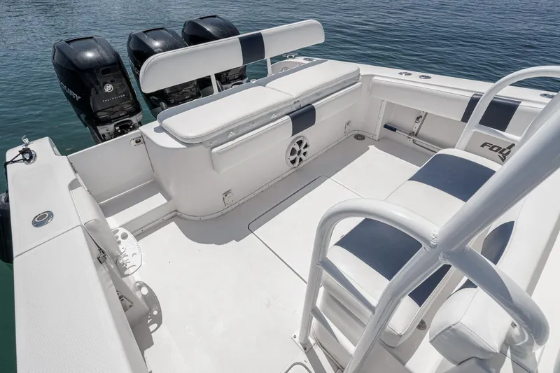 Slide: The Image of 2019 Fountain 38 CC boat interior with seating and triple Mercury outboard engines. - 25