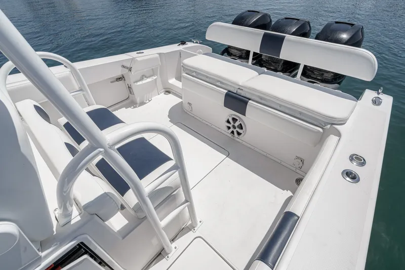 Slide: The Image of 2019 Fountain 38 CC boat interior with seating and triple outboard engines. - 26