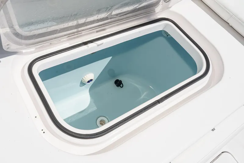 Slide: The Image of Open storage compartment on 2019 Fountain 38 CC boat, featuring a clean, white interior. - 28