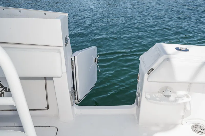 Slide: The Image of 2019 Fountain 38 CC boat with open side door, overlooking calm water. - 31