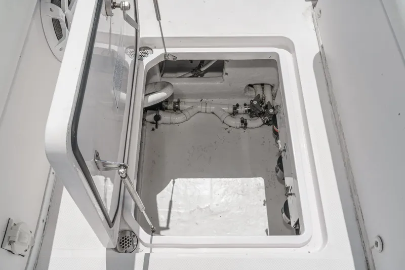 Slide: The Image of Open hatch of 2019 Fountain 38 CC boat showing interior components and piping. - 33