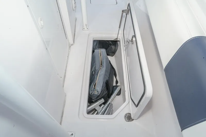 Slide: The Image of Open storage compartment on 2019 Fountain 38 CC boat, containing equipment and gear. - 35
