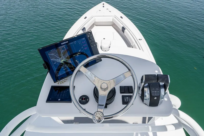 Slide: The Image of 2019 Fountain 38 CC boat helm with navigation system and controls on calm water. - 9