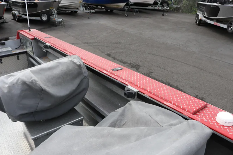 Slide: The Image of 2026 North River SCOUT boat interior with red diamond plate accents and covered seats. - 18