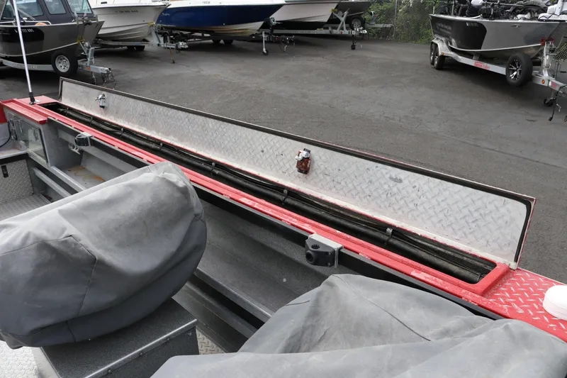 Slide: The Image of 2026 North River SCOUT boat interior with covered seats and storage compartment. - 19