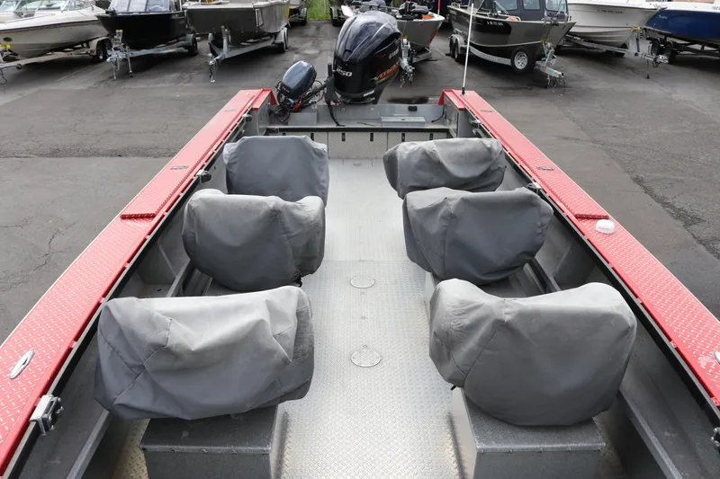 Slide: The Image of 2026 North River SCOUT boat interior with covered seats and outboard motor. - 5
