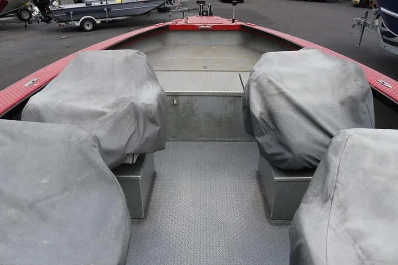 Slide: The Image of 2026 North River SCOUT boat interior with covered seats and red accents. - 7