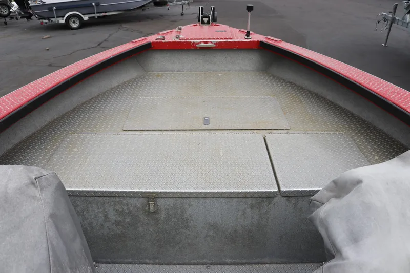 Slide: The Image of 2026 North River SCOUT boat interior with diamond plate flooring and red trim. - 8
