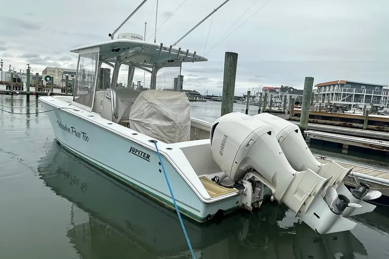 The Image of 2013 Jupiter 30 Center Console boat docked with twin Yamaha engines. - 1