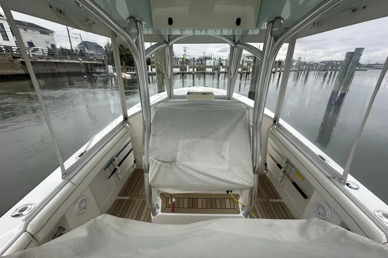 Slide: The Image of 2013 Jupiter 30 Center Console boat interior at a marina dock. - 12