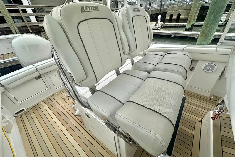 Slide: The Image of 2013 Jupiter 30 Center Console boat with cushioned seating and teak flooring. - 13