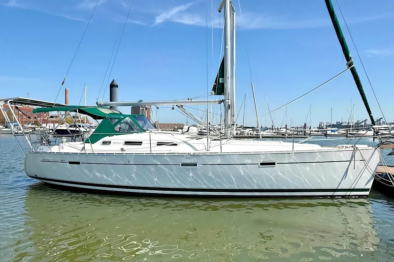 The Image of 2003 Beneteau 393 sailboat docked in a marina under clear blue skies. - 1