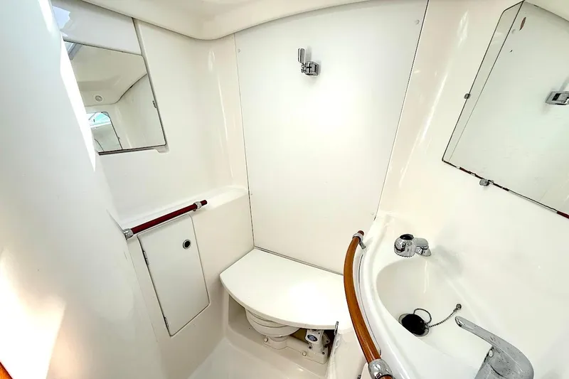 Slide: The Image of 2003 Beneteau 393 yacht bathroom with sink, mirror, and toilet. - 21
