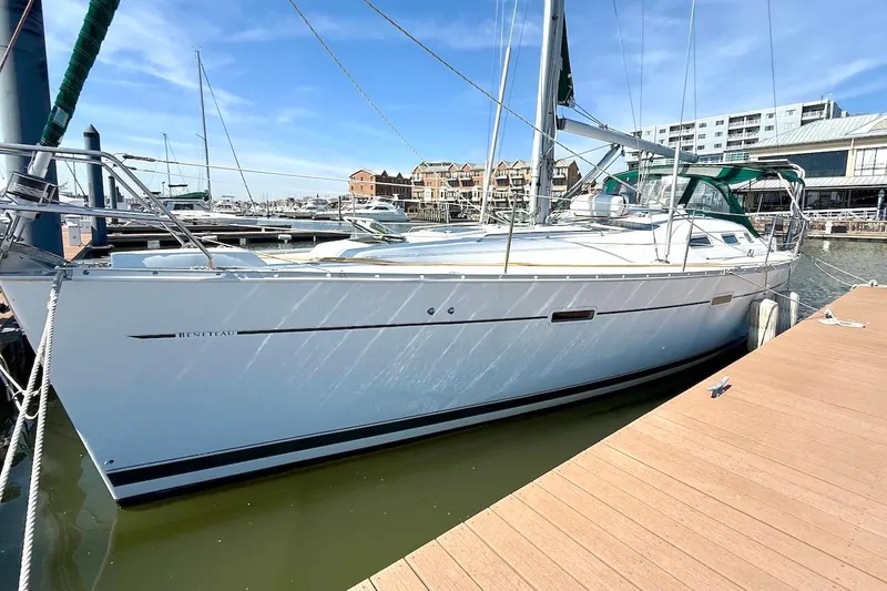 Slide: The Image of 2003 Beneteau 393 sailboat docked at marina under clear blue sky. - 3