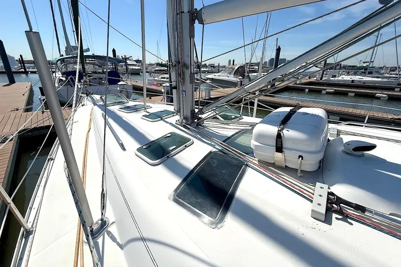 Slide: The Image of 2003 Beneteau 393 sailboat docked at marina, showcasing deck and rigging. - 4