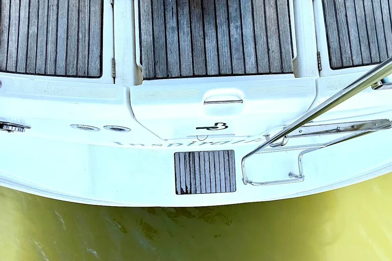 Slide: The Image of Rear view of a 2003 Beneteau 393 yacht with wooden deck details. - 9