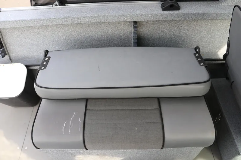 Slide: The Image of 2004 Alumaweld STRYKER 19 boat seat with gray upholstery and visible wear. - 12