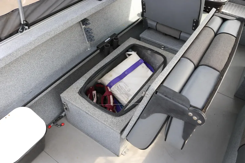 Slide: The Image of 2004 Alumaweld STRYKER 19 boat interior with storage compartment and seating. - 13