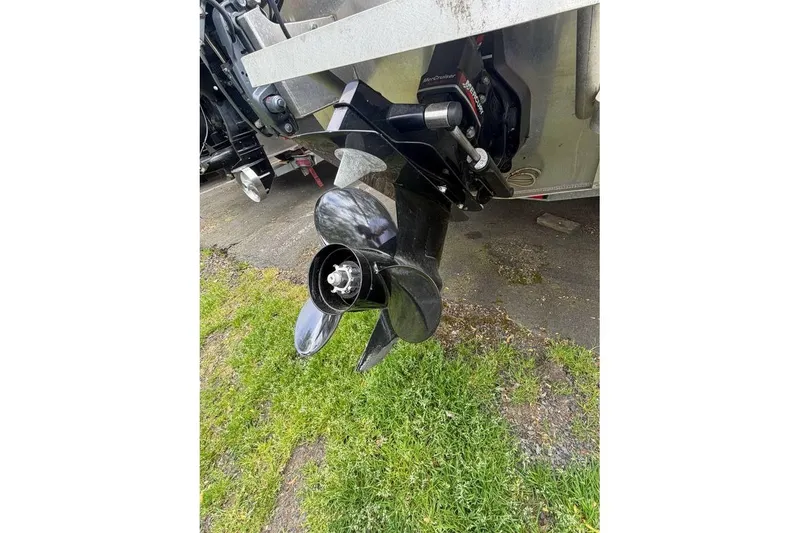 Slide: The Image of 2004 Alumaweld STRYKER 19 boat propeller on grass, showcasing its sleek design. - 8