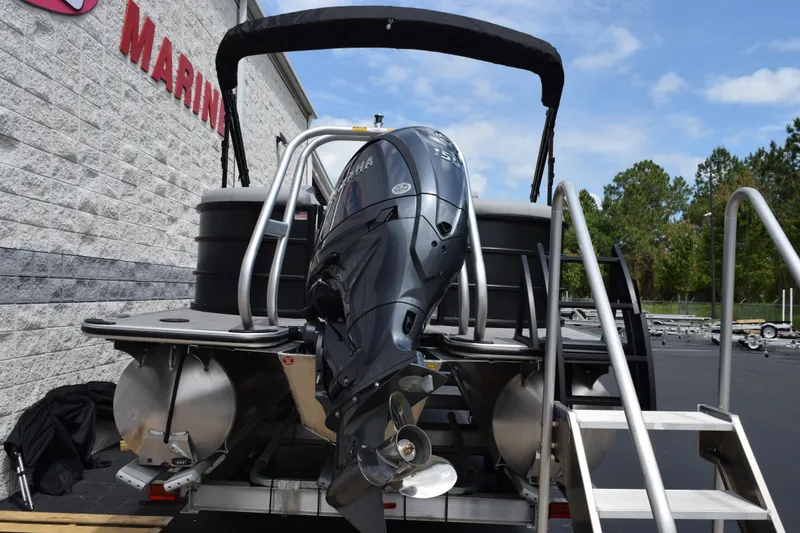 Slide: The Image of 2026 Bentley Pontoons Legacy 223 Navigator with Yamaha outboard motor, docked at marina. - 5