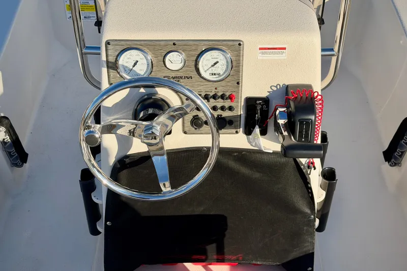 Slide: The Image of 2026 Carolina Skiff E16 JVX CC boat console with steering wheel and gauges. - 13