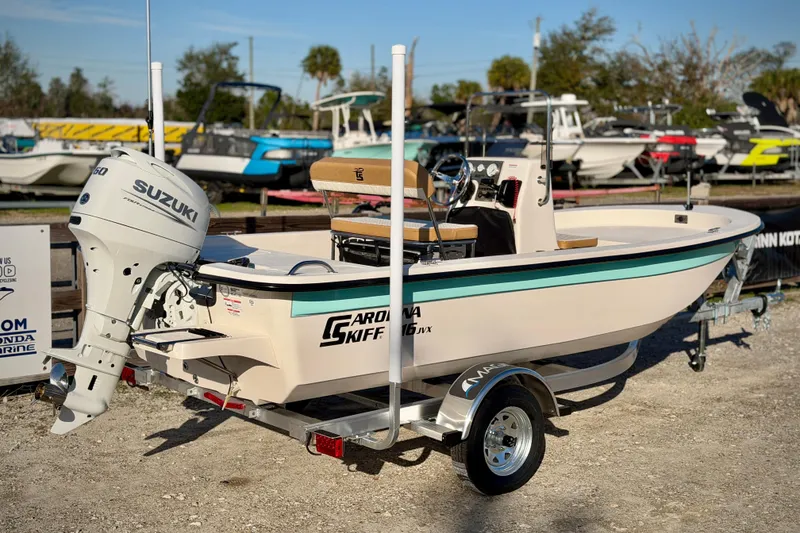 Slide: The Image of 2026 Carolina Skiff E16 JVX CC boat with Suzuki outboard motor on trailer. - 15