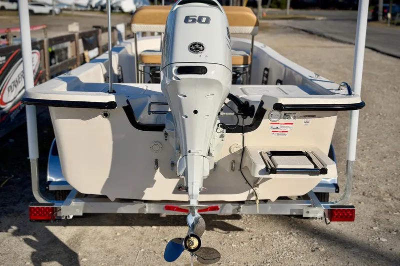 Slide: The Image of 2026 Carolina Skiff E16 JVX CC boat with 60 HP outboard motor, rear view. - 3