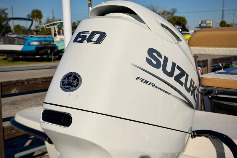 Slide: The Image of Suzuki 60 horsepower four-stroke outboard motor on a 2026 Carolina Skiff E16 JVX CC boat. - 6