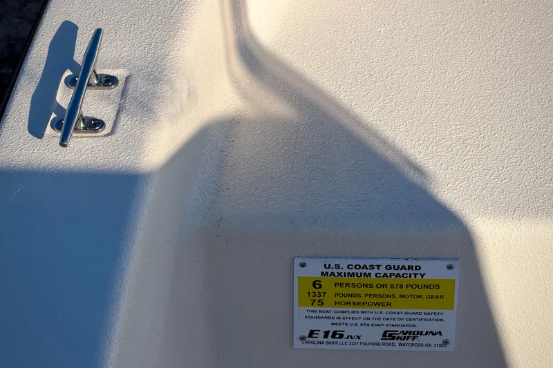 Slide: The Image of 2026 Carolina Skiff E16 JVX CC boat capacity label, showing U.S. Coast Guard compliance. - 8