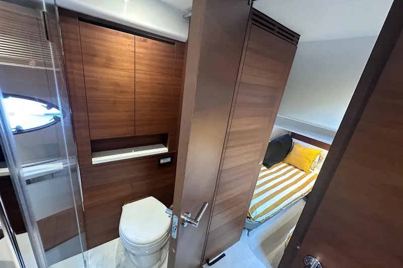 Slide: The Image of Luxurious 2018 Princess F43 yacht interior with wooden cabinetry and cozy bedroom. - 11