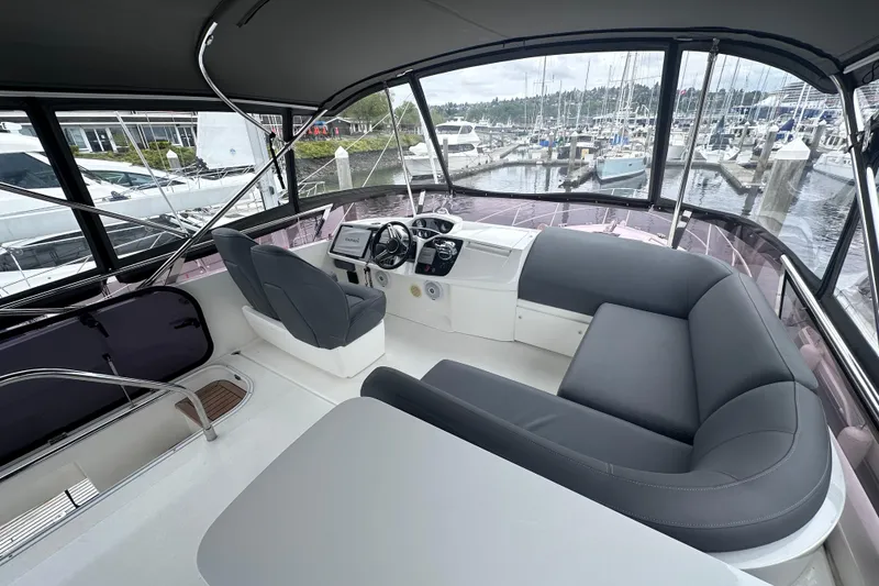 Slide: The Image of Luxurious 2018 Princess F43 yacht interior with sleek seating and modern controls at marina. - 12