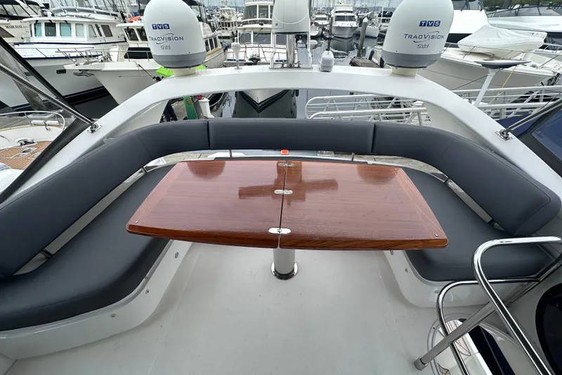 Slide: The Image of Luxurious 2018 Princess F43 yacht with elegant seating and wooden table on deck. - 14