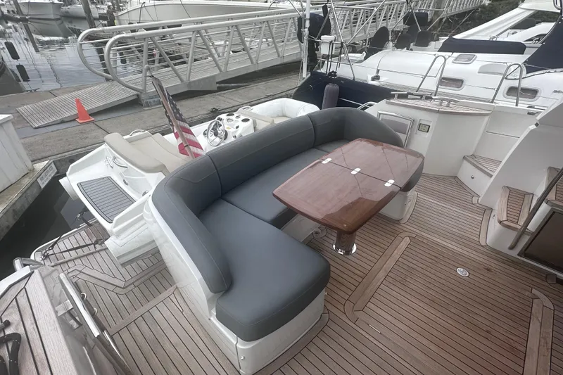 Slide: The Image of Luxury yacht Princess F43, 2018 model, featuring elegant deck seating and wooden table. - 2