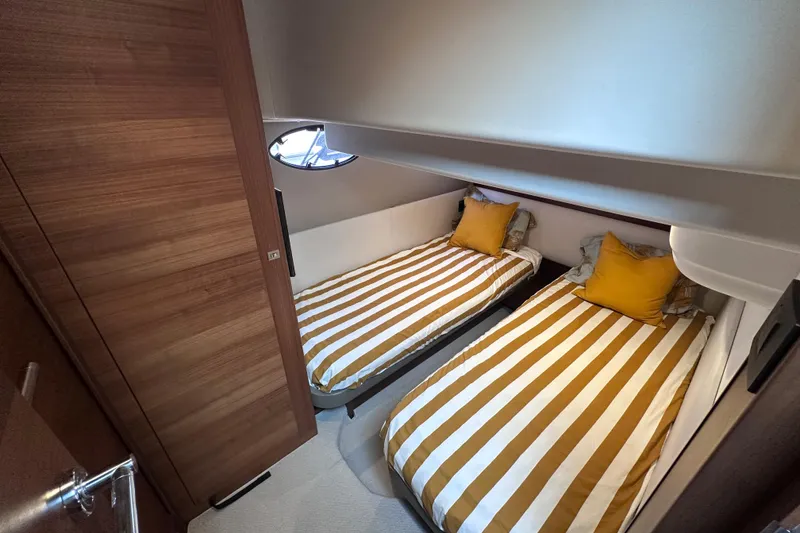 Slide: The Image of Twin cabin with striped bedding in 2018 Princess F43 yacht interior. - 28