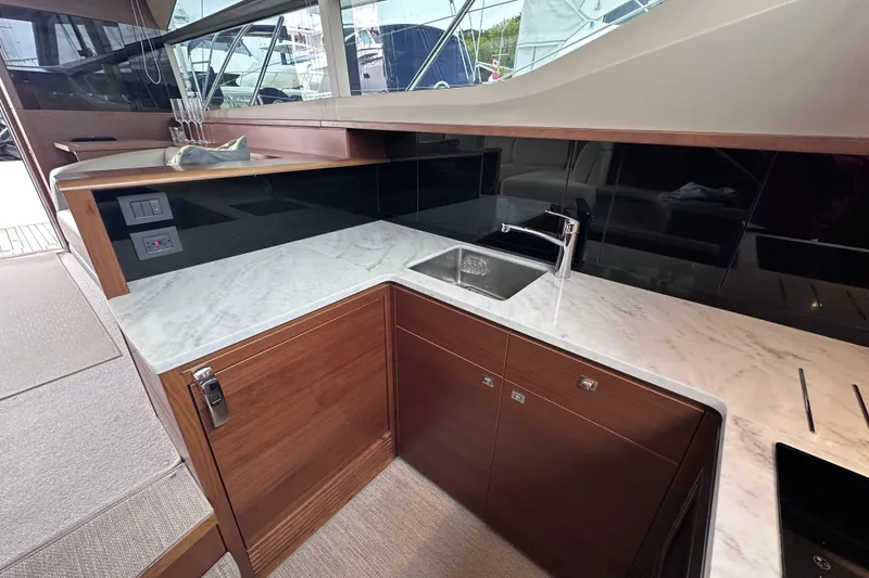 Slide: The Image of Luxurious kitchen area in a 2018 Princess F43 yacht with marble countertops and modern fixtures. - 36