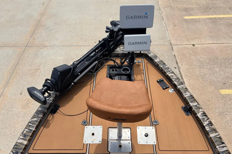 Slide: The Image of 2023 Avid 21 XB Elite boat with Garmin electronics and a brown seat on deck. - 10