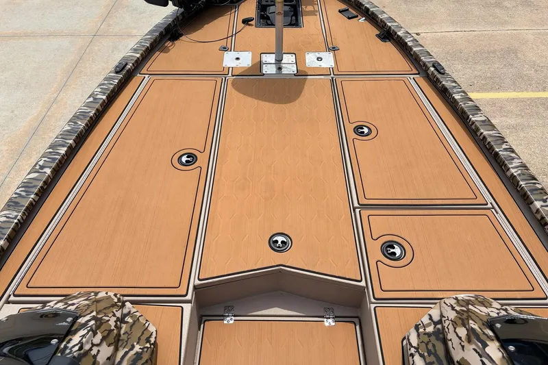 Slide: The Image of 2023 Avid 21 XB Elite boat deck with camo trim and storage compartments. - 15