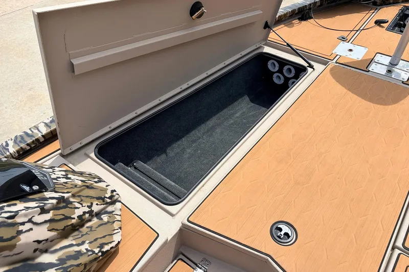 Slide: The Image of 2023 Avid 21 XB Elite boat storage compartment with open lid, showcasing interior space. - 17