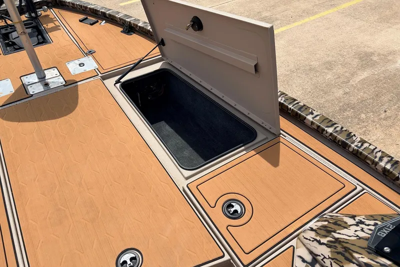 Slide: The Image of 2023 Avid 21 XB Elite boat deck with open storage compartment. - 22