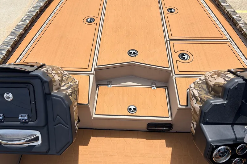 Slide: The Image of 2023 Avid 21 XB Elite boat deck with camo accents and storage compartments. - 26