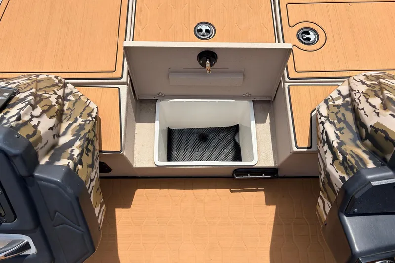 Slide: The Image of 2023 Avid 21 XB Elite boat deck with storage compartment and camouflage motor covers. - 27
